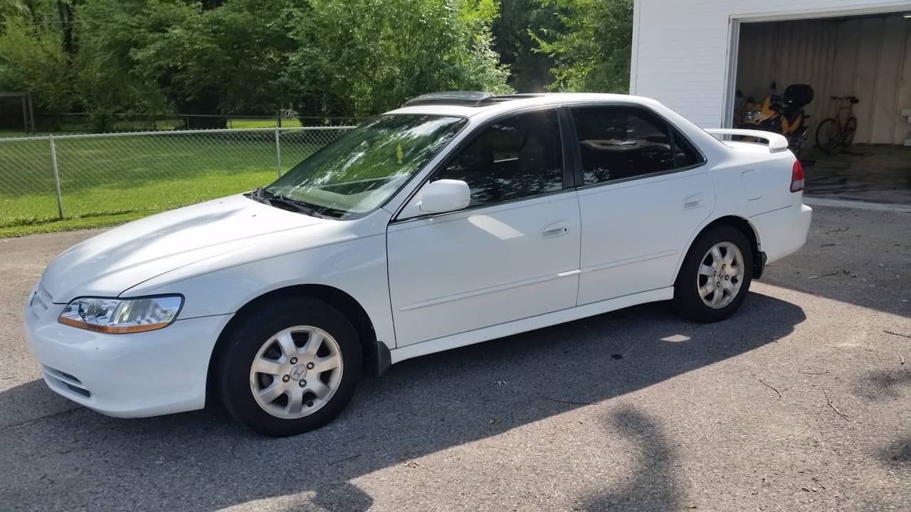 White 2002 Honda Accord sedan parked in a driveway with dark window tint installed on the rear and side windows