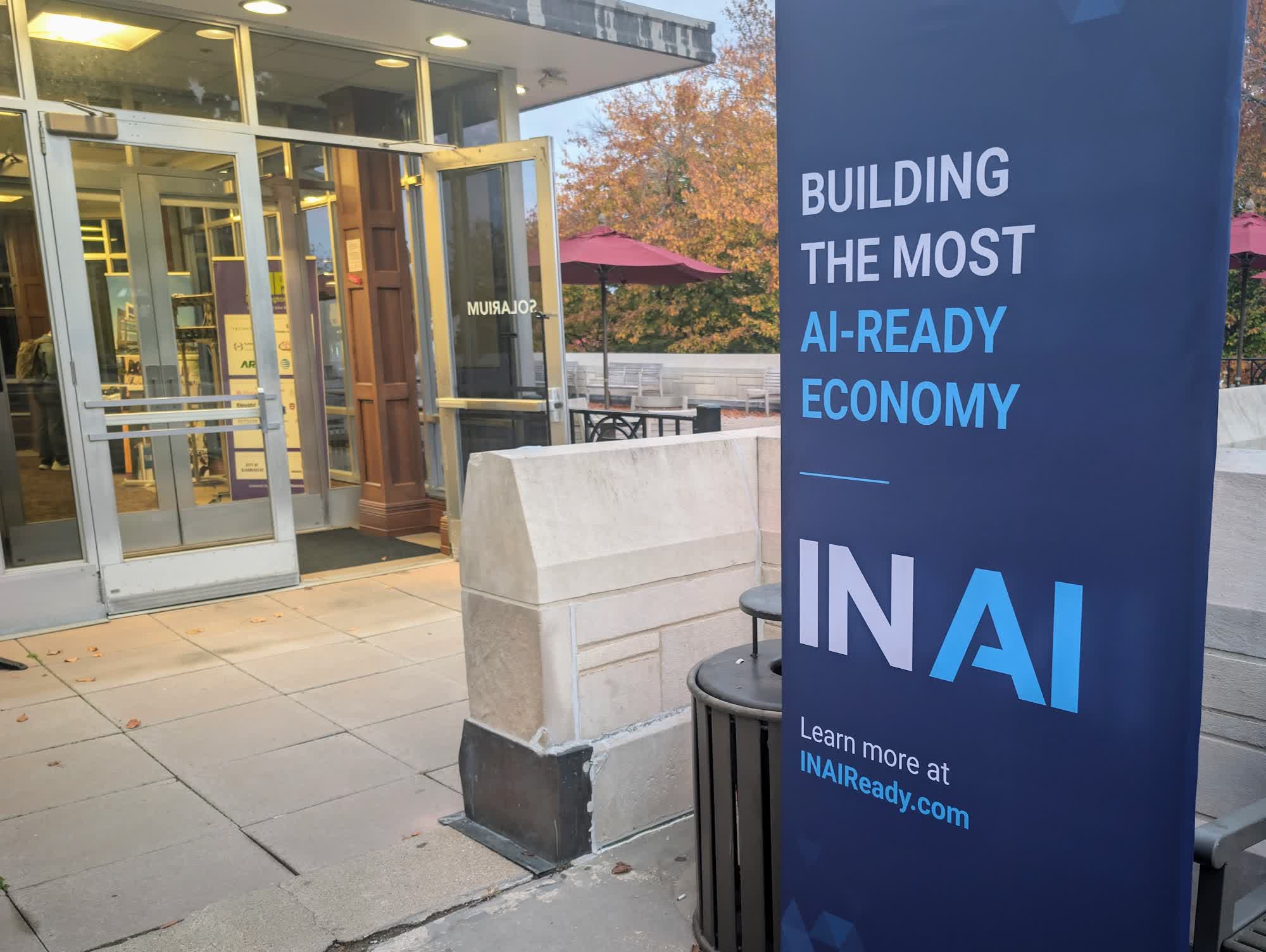 Blue IN AI banner reading Building the most AI-ready economy beside the entrance of The Mill in Bloomington