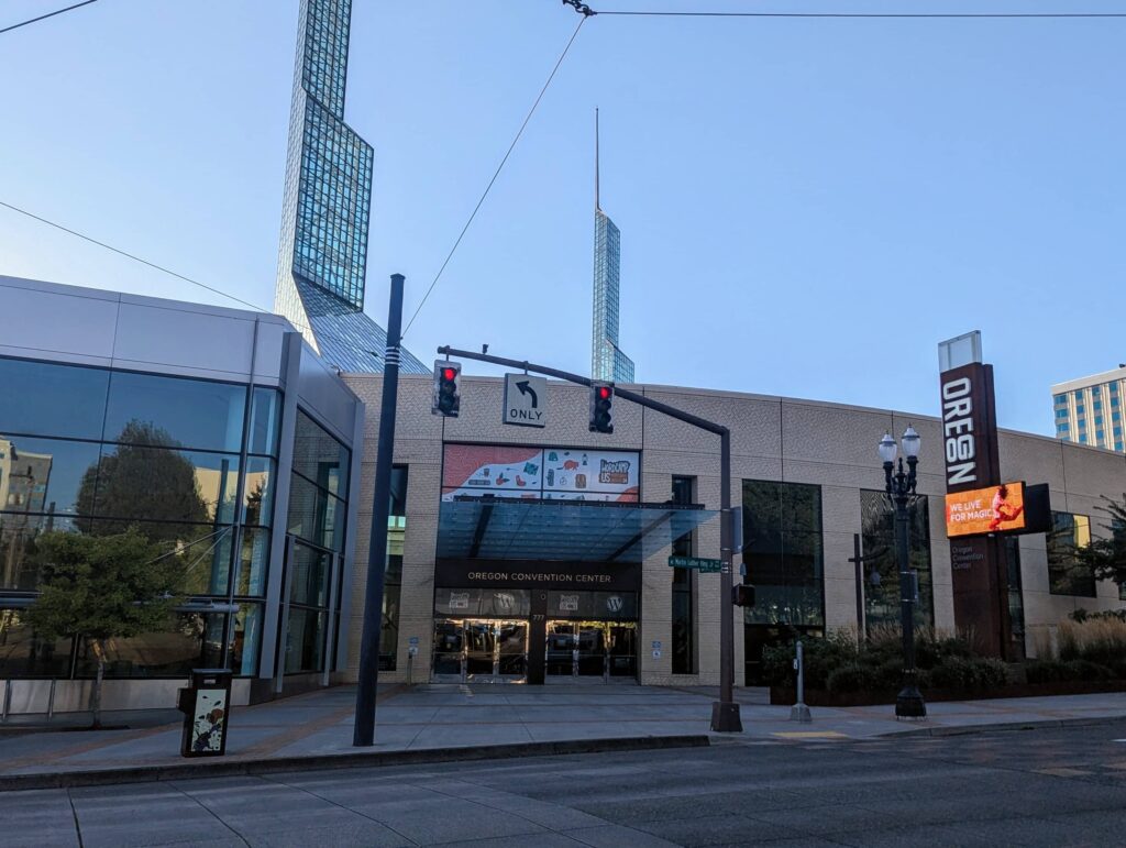 The exterior of the Oregon Convention Center in Portland, Oregon, with its distinct spire towers and glass facade, welcoming attendees for WordCamp US 2024.