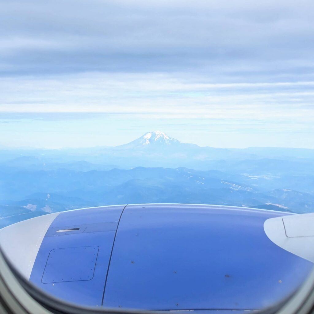 Aerial view of Mt. Hood as seen from a Southwest Airlines flight, with the plane’s wing visible in the foreground.